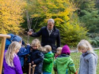 Prof. Dr. Eckart Würzner pflanzt gemeinsam mit Kindern der Kita Wörterwald einen Zwetschgenbaum. (Foto: Dittmer) Oberbürgermeister Würzner pflanzt einen Baum, viele Kinder sind dabei und helfen ihm.